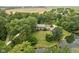 Majestic aerial view of an estate with a pond, lush greenery, and a grand home at 10198 N State Road 75, North Salem, IN 46165