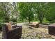 Outdoor patio with comfortable wicker furniture, surrounded by mature trees and lush landscaping at 10198 N State Road 75, North Salem, IN 46165