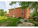 Expansive brick home featuring a landscaped backyard and patio with outdoor seating at 10198 N State Road 75, North Salem, IN 46165