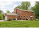 Expansive backyard with brick home, attached garage, patio seating, and well-maintained lawn at 10198 N State Road 75, North Salem, IN 46165