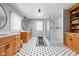 Modern bathroom with a glass-enclosed shower, double vanities, and stylish black and white tile flooring at 10198 N State Road 75, North Salem, IN 46165