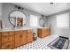 Bright bathroom with dual vanities, round mirrors, and hexagon tile flooring at 10198 N State Road 75, North Salem, IN 46165