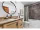 Stylish bathroom with granite countertops, oval mirror, and tiled shower with shower curtain at 10198 N State Road 75, North Salem, IN 46165