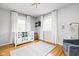 Bright Bedroom featuring a crib, rocking chair, modern lighting, and stylish decor at 10198 N State Road 75, North Salem, IN 46165