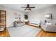 Cozy Bedroom with grey armchairs, crib, modern lighting, shelving, and decorative prints at 10198 N State Road 75, North Salem, IN 46165