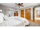 Bright bedroom with a ceiling fan, wood floors, closet and view to attached bathroom at 10198 N State Road 75, North Salem, IN 46165