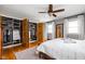 Spacious bedroom with wood floors, open closet, windows, and a full-length mirror at 10198 N State Road 75, North Salem, IN 46165