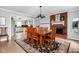 Open dining room featuring a fireplace, area rug, and an open concept to the kitchen at 10198 N State Road 75, North Salem, IN 46165