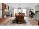 Bright dining room boasts a fireplace, chandelier, and decorative area rug at 10198 N State Road 75, North Salem, IN 46165