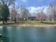 Exterior shot of the home featuring a pond, brick facade, columns and flowering trees at 10198 N State Road 75, North Salem, IN 46165