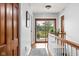 Bright hallway featuring hardwood floors, white walls, and a glass door with a view of trees at 10198 N State Road 75, North Salem, IN 46165