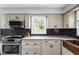 Bright kitchen featuring granite countertops, modern appliances, and black subway tile backsplash at 10198 N State Road 75, North Salem, IN 46165