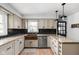 Well-lit kitchen featuring granite countertops, a stainless steel dishwasher, and black subway tile backsplash at 10198 N State Road 75, North Salem, IN 46165