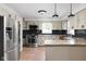 Modern kitchen featuring stainless steel appliances, granite countertops, and black subway tile at 10198 N State Road 75, North Salem, IN 46165