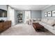 Bright living room featuring a comfortable sectional sofa, modern shelving, and large windows at 10198 N State Road 75, North Salem, IN 46165