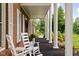 Inviting covered porch with white rocking chairs and elegant columns, perfect for relaxing outdoors at 10198 N State Road 75, North Salem, IN 46165