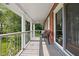 Inviting porch with white columns, outdoor seating, and a view of the lush green lawn at 10198 N State Road 75, North Salem, IN 46165