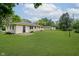 Large backyard with lush lawn, mature trees, and a view of the home's rear exterior at 10434 N Delaware St, Carmel, IN 46280