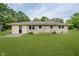 Well-maintained backyard showcasing a lush lawn and the rear exterior of the home at 10434 N Delaware St, Carmel, IN 46280