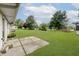 Expansive backyard featuring well-kept lawn, mature trees, and a concrete patio at 10434 N Delaware St, Carmel, IN 46280