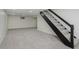 Carpeted basement with stairs leading to the upper level and a small window at 10434 N Delaware St, Carmel, IN 46280