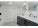 Bright bathroom featuring a double sink vanity with modern matte black fixtures and tiled floors at 10434 N Delaware St, Carmel, IN 46280