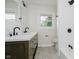 Modern bathroom featuring a double sink vanity, tiled floors, and a walk-in shower at 10434 N Delaware St, Carmel, IN 46280