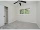 Bright bedroom with a ceiling fan, closet, and a window overlooking the outdoor greenery at 10434 N Delaware St, Carmel, IN 46280
