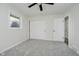 Bright bedroom featuring a ceiling fan, closet, and a window overlooking the outdoor greenery at 10434 N Delaware St, Carmel, IN 46280