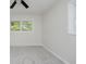 Bright bedroom with a window overlooking outdoor greenery and neutral-colored walls and carpeting at 10434 N Delaware St, Carmel, IN 46280