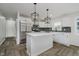 Modern kitchen features new stainless steel appliances, a center island, and stylish lighting at 10434 N Delaware St, Carmel, IN 46280