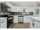 Modern kitchen featuring stainless steel appliances, backsplash, and luxury vinyl flooring at 10434 N Delaware St, Carmel, IN 46280