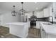 Modern kitchen features a center island, stainless steel appliances, and luxury vinyl flooring at 10434 N Delaware St, Carmel, IN 46280