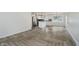 Open-concept living room with luxury vinyl flooring and abundant natural light at 10434 N Delaware St, Carmel, IN 46280