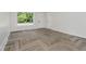 Bright room features luxury vinyl flooring, a large window, and a white painted door at 10434 N Delaware St, Carmel, IN 46280