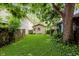 Backyard featuring detached garage with green lawn, ideal for outdoor activities at 1051 Elm St, Indianapolis, IN 46203