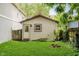 Detached garage with green lawn and aged brick fire pit, creating a tranquil outdoor space at 1051 Elm St, Indianapolis, IN 46203