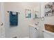 Cozy bathroom featuring modern vanity with framed art and bronze fixtures, blending functionality with style at 1051 Elm St, Indianapolis, IN 46203