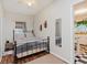 Well-lit bedroom with a metal bed frame, wood floors, and neutral walls at 1051 Elm St, Indianapolis, IN 46203