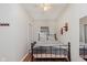 Inviting bedroom with a metal bed frame, wood floors, and ample natural light at 1051 Elm St, Indianapolis, IN 46203