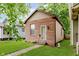 Charming home featuring a red brick facade, green lawn, and a classic design at 1051 Elm St, Indianapolis, IN 46203