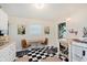 Bright kitchen featuring a dining table, decor, white cabinets, butcher block countertops, and checkered floors at 1051 Elm St, Indianapolis, IN 46203
