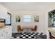 Bright kitchen featuring a dining table, decor, white cabinets, and checkered floors at 1051 Elm St, Indianapolis, IN 46203