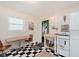 Bright kitchen featuring a dining table, gas range, decor, white cabinets, butcher block countertops, and checkered floors at 1051 Elm St, Indianapolis, IN 46203