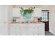 Bright kitchen featuring a window over the sink, white cabinets, and butcher block countertops at 1051 Elm St, Indianapolis, IN 46203