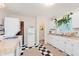 Bright kitchen with white cabinets, checkered floors, retro refrigerator, and butcher block countertops at 1051 Elm St, Indianapolis, IN 46203