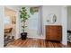 Bright living room featuring a window, houseplant, dresser, and stylish decor at 1051 Elm St, Indianapolis, IN 46203