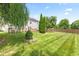 Large, level backyard with mature trees and a wooden fence at 10611 Armstead Ave, Indianapolis, IN 46234