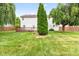 Spacious backyard with lush green grass, mature trees, and a privacy fence at 10611 Armstead Ave, Indianapolis, IN 46234