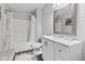 Clean bathroom with a white vanity, mirror, shower, tub, and gray brick accent wall at 10611 Armstead Ave, Indianapolis, IN 46234